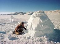 An Inuit covers the opening of an iglu
