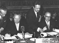 German Chancellor Konrad Adenauer (left) places his signature on the treaties