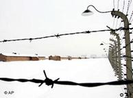 Barbed wire fences surround buildings at Auschwitz