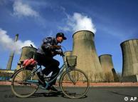 A man cycles past an electricity plant in China