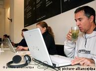 Two people use laptop computers in the St Oberholz cafe