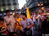 Pilgrims pray as a demonstrator shouts slogans against the visit of Pope Benedict XVI in Madrid