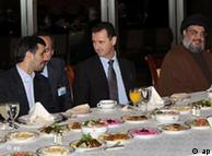 Iranian President Mahmoud Ahmadinejad, left, speaks with Syrian President Bashar Assad, center, as Hezbollah leader sheik Hassan Nasrallah, right, sits next to them 