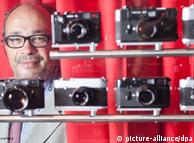 Leica supervisory board chairman Andreas Kaufmann poses with cameras