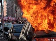 A car is set on fire as protesters clash with police in Rome, Saturday, Oct. 15, 2011. Protesters in Rome smashed shop windows and torched cars as violence broke out during a demonstration in the Italian capital, part of worldwide protests against corporate greed and austerity measures. The 