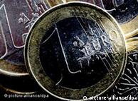Eurozone flags set up around a euro coin