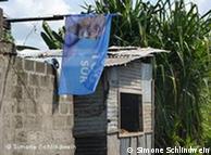 Ramshackle building with campaign flag in Congo