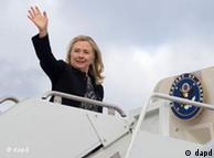 Hillary  Clinton waves prior to boarding her airplane 