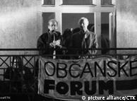 Vaclav Havel (left) speaks from the balcony of the Melantrich publishing house which served as the Civic Forum headquarters during demonstrations in Wenceslas Square in 1989