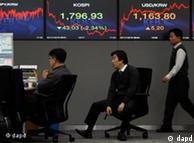 Currency traders talk in front of the screens showing the Korea Composite Stock Price Index, left, and foreign exchange rates at the foreign exchange dealing room of the Korea Exchange Bank headquarters in Seoul, South Korea, Monday, Dec. 19, 2011. Asian stock markets slid Monday amid news that the mercurial leader of nuclear-armed North Korea has died, raising fears of increased political instability in the region. (AP Photo/ Lee Jin-man)
