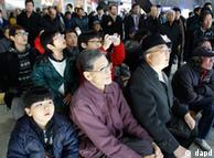Passengers watch a TV news reporting about the death of North Korean leader Kim Jong Il at the Seoul train station in Seoul, South Korea, Monday, Dec. 19, 2011. (AP Photo/Lee Jin-man)
