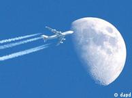 airplane flying against the moon