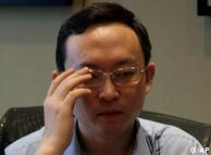 Chinese writer Yu Jie adjusts his glasses during an interview in Beijing, China