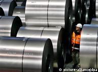 Worker surveys steel spools