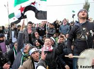 Demonstrators hold up Kurdish and the Syrian independence flag during a protest against Syria's President 