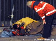 An emergency official speaks with a homeless person in Berlin