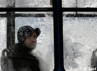 A man looks from behind a frosty window on a tram in Sofia