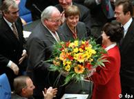 Former chancellor Helmut Kohl (second left) accepts a wreith after being elected chancellor in 1994, as then-FDP leader Klaus Kinkel (right) looks on