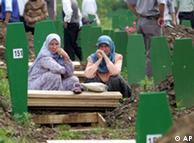 Muslim women mourning at a mass grave near Srebrenica