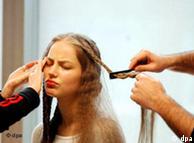 a woman looking unhappy as her hair is being done