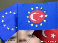 Child holding a yellow-starred EU flag with the Turkish crescent and star in the middle