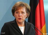 German Chancellor Merkel speaking at a podium in front of the German flag
