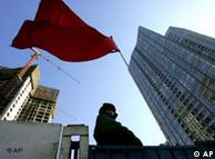 A security guard stands on a construction site in Beijing Tuesday, Dec. 20, 2005. China sharply raised the official size of its economy Tuesday after taking into account emerging service industries, saying its output last year was 16.8 percent higher than previously reported. (AP Photo/Greg Baker)