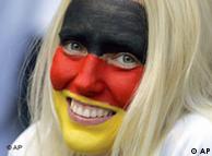 Fan with face painted in colors of German flag
