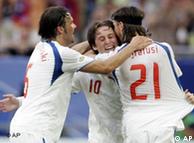 Czech Republic's Tomas Rosicky (center), who scored twice, is hugged by team mates 