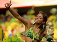 A supporter of Brazil's soccer team cheers with a replica of the World Cup trophy in Germany last year