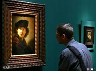 A man looks at a self-portrait of Rembrandt (1634) in Berlin's Gemaelde Galerie