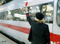 A conductor signals a train