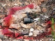 A cluster bomb used by Israel in Lebanon is marked by red painting on the Lebanon-Israeli border road near the southern Lebanese village of Naqura in August 2006