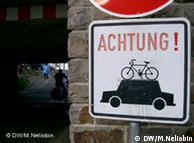 Sign with a car on top of a bike