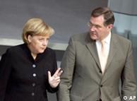 Merkel, standing next to Jung, looks angry