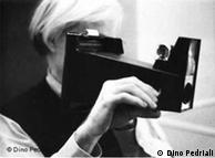 Andy Warhol with a Polaroid camera