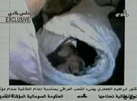 Saddam Hussein's body wrapped in a white shroud following his execution