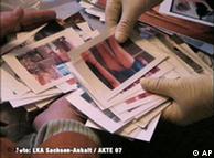 Gloved hands sorting through pornographic pictures