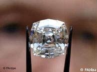 A diamond held in tweezers