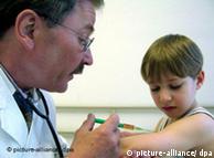 A doctor gives a child an injection in the arm