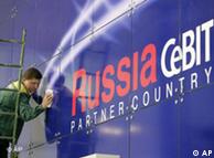 A man wiping a wall at the booth of the partner country Russia at the CeBIT in Hanover
