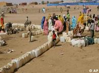 Darfur refugees line up for water in the Abu Shouk refugee camp, north Darfur, Sudan 