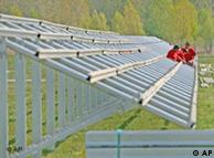 Workers erect a solar power plant near Leipzig
