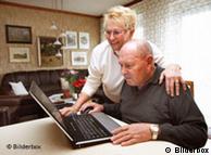 Two retired people looking at a laptop screen