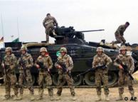 Bundeswehr soldiers in front of a tank in Afghanistan