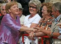 Angela Merkel greets by-standers outside the Wagner festival theater
