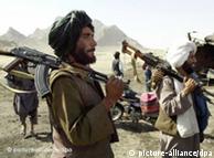 Taliban militants carrying weapons