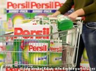 A shopping cart filled with a box of Persil detergent