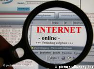 A magnifying glass focused on the word Internet on a computer monitor