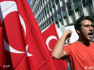 A demonstrator, with Turkish flags next to him, shouts anti-American slogans during a protest 